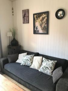 a couch in a living room with pillows on it at Au près de tout in Neuvecelle