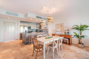 a kitchen and dining room with a table and chairs at Apt with picuzzi in Cap Cana at Punta Palmera BA5 in Punta Cana