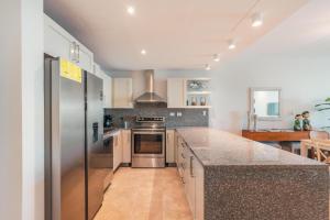 a kitchen with stainless steel appliances and a counter top at Apt with picuzzi in Cap Cana at Punta Palmera BA5 in Punta Cana