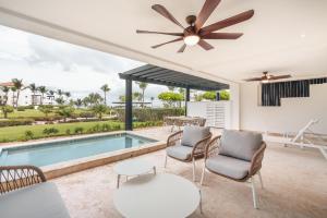 a living room with a pool and a ceiling fan at Apt with picuzzi in Cap Cana at Punta Palmera BA5 in Punta Cana