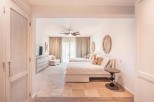 a bedroom with two beds and a ceiling fan at Apt with picuzzi in Cap Cana at Punta Palmera BA5 in Punta Cana +16 photos