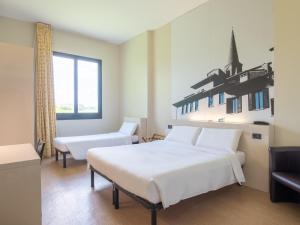 Postel nebo postele na pokoji v ubytování B&B HOTEL Mantova