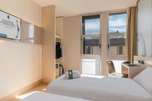 A bed or beds in a room at B&B Hotel Firenze City Center