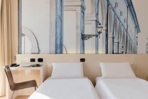 A bed or beds in a room at B&B Hotel Firenze City Center