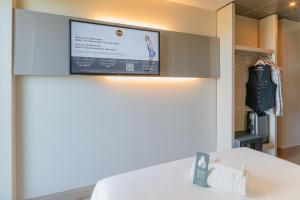 A bed or beds in a room at B&B Hotel Firenze City Center