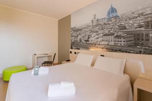 A bed or beds in a room at B&B Hotel Firenze City Center