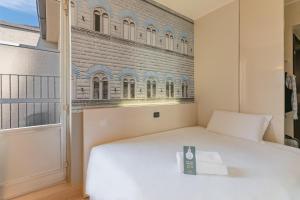 A bed or beds in a room at B&B Hotel Firenze City Center