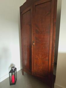 a wooden door in a room with a candle next to it at Dimora Storica Apartments in Ruviano