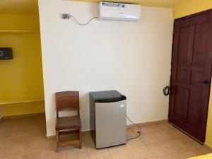 a room with a heater and a chair and a door at Uverito Sand Dollar B&B in Las Tablas