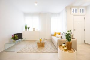 a living room with a couch and a table at Vallecas Apartments in Madrid
