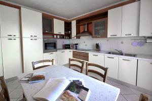 a kitchen with a table with a book on it at Affitto Breve Rovigo La Casa sul Grande Fiume Po di Nadine in Guarda Veneta