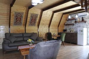 a living room with a couch and a table at Ecohouse Machakhela 4 in Machakhela