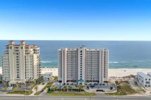 2 grands bâtiments blancs à côté de la plage dans l'établissement Windemere Unit 1006, à Pensacola