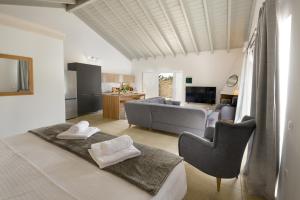 a room with a bed and a living room at Kalokairia Residence in Gaios