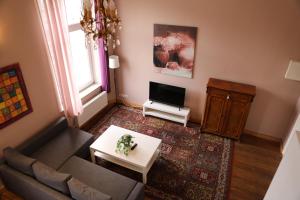 un soggiorno con un divano e una TV di Royal Rose Suite in zentraler Lage a Brema