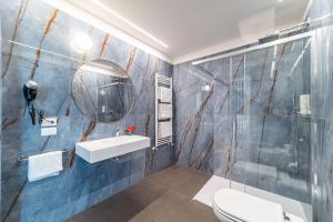a bathroom with a toilet and a sink and a shower at Hotel Terme Milano in Abano Terme