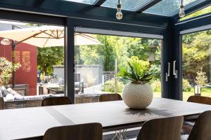 a dining room with a table with a vase on it at Villa von Maximus in Leipzig