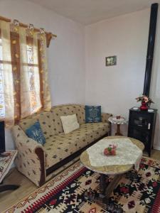 a living room with a couch and a table at Guest House Vajzë S,Kasaj in Vlorë