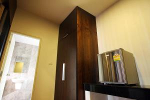 a bathroom with a small television on a shelf at Rongsang Resort in Nong Khae