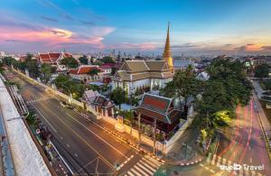 an overhead view of a city with a street and a church at Cha Na Stay at Merry V in Bangkok