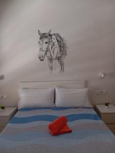 a drawing of a woman riding a horse on a bed at Brisa del Mar - 2 min playa in El Ejido +7 photos