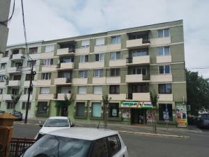 a white car parked in front of a building at Central White Apartment in Satu Mare
