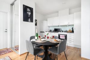 a kitchen and dining room with a table and chairs at Central Big and Bright Resting place in Trondheim