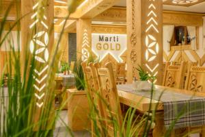 a restaurant with a table and a sign that reads math gold at Willa Marti GOLD in Zakopane