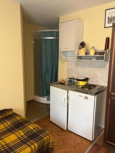 a small kitchen with a stove and a refrigerator at Apartments Londa in Jūrmala