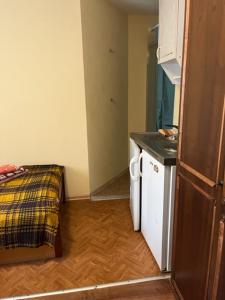 a small room with a kitchen and a bed at Apartments Londa in Jūrmala