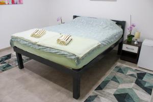 a bed with two pillows on it in a room at Apartman Nadja&Dani in Kulen Vakuf