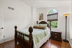 a bedroom with a bed and a window at 5 Minutes from Hospitals and UK! in Lexington