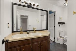 a bathroom with two sinks and a large mirror at 5 Minutes from Hospitals and UK! in Lexington +33 photos