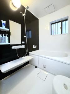 a bathroom with a sink and a toilet and a mirror at guesthouse大阪城 in Osaka