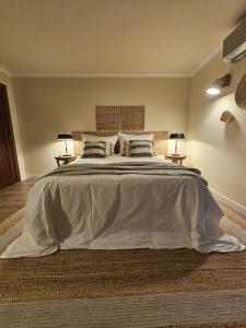 a large bed in a bedroom with two night stands at Casa da Fidalga in Outeiro de Gatos +67 photos