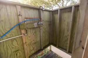 a wooden fence with a hose attached to it at Vintage OBX in Sanderling
