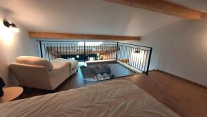 a living room with a bed and a balcony at Au mignon filet de St Nazaire in Saint-Nazaire-en-Royans