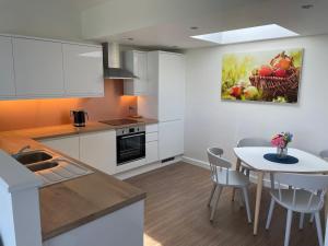 a kitchen with a table and a dining room at Flatholm in Brean