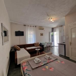 a living room with a bed and a couch and a table at Apartmani Vlahović in Sutomore