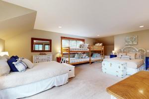 a bedroom with two beds and a table at Echo Lake Family Fun in Bigfork