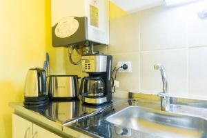 a coffee maker on a counter in a kitchen at Gente del Sur - Odino in Ushuaia +18 photos