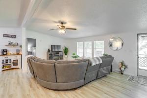 a living room with a couch and a ceiling fan at North Fairfield Family Home with Hot Tub and Porch! in Willard
