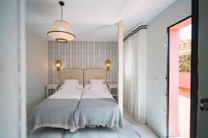 Posteľ alebo postele v izbe v ubytovaní San Clemente House