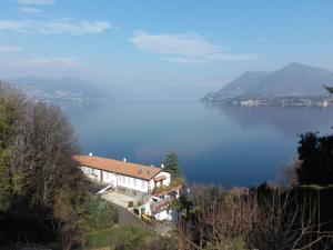 a house on a hill next to a large body of water at Lago Blu in Stresa