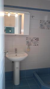 a bathroom with a sink and a mirror at Pefki Apartment 6 in Artemísion +13 photos