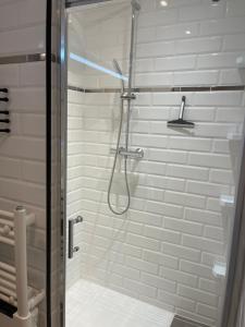 a shower with a glass door in a bathroom at Villa bord de mer deux ch sdb privative in Agde