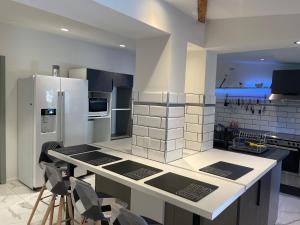 a kitchen with a white refrigerator and a counter at Villa bord de mer deux ch sdb privative in Agde +11 photos