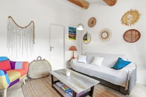 a living room with a couch and a table at Appartement Domi in Grimaud +16 photos
