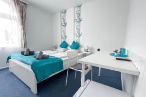 a bedroom with a bed and a desk and a table at Manna Villa in Balatonfüred +5 photos