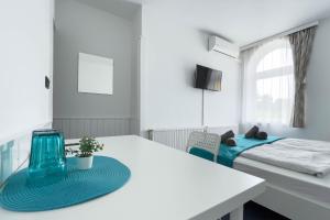 a small room with a table and a bed at Manna Villa in Balatonfüred